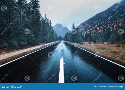 Asphalt Mountain Road In Foggy Forest In Overcast Rainy Day Stock Photo