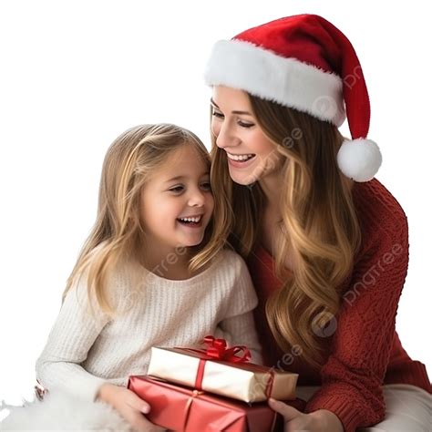 فتاة ترتدي قبعة سانتا كلوز عند شجرة عيد الميلاد بجوار ابنتها مع صندوق هدايا فتاة عيد الميلاد