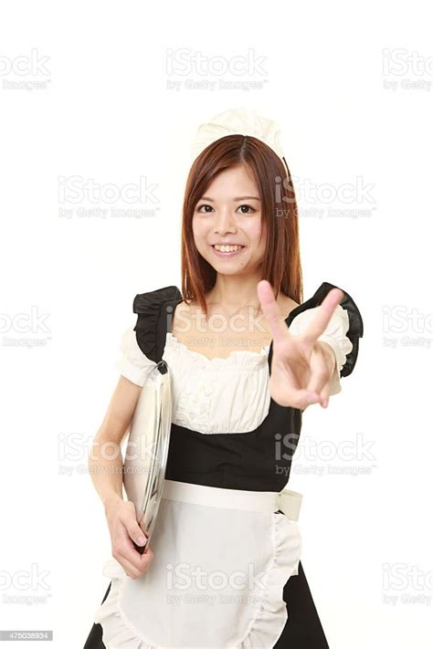 Japanese Woman Wearing French Maid Costume Showing A Victory Sign Stock