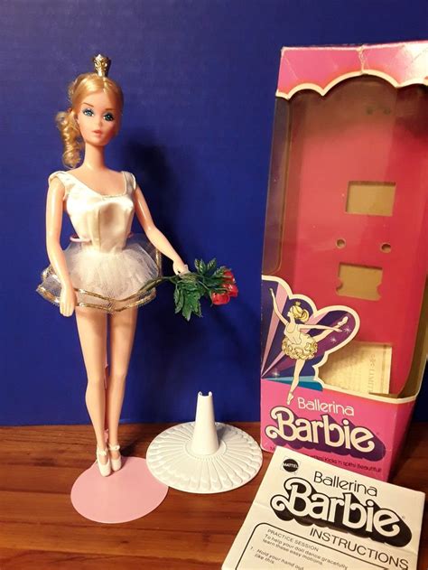 A Barbie Doll Is Standing Next To A Box