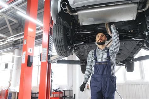 Handsome Car Mechanic Is Posing In A Car Service Stock Photo Image