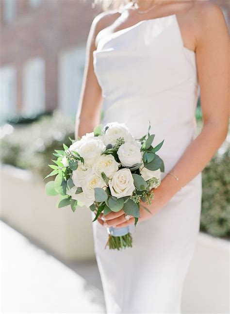 bridal bouquet with white roses and eucalyptus leaves wrapped with pale blue ribbon bride