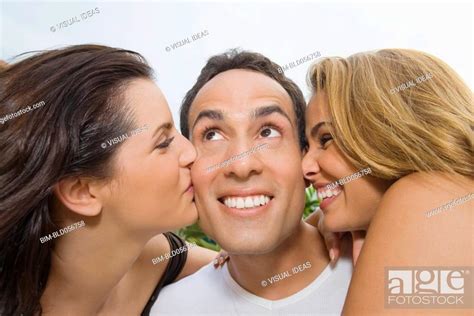 Hispanic Women Kissing Man On Cheeks Stock Photo Picture And Royalty