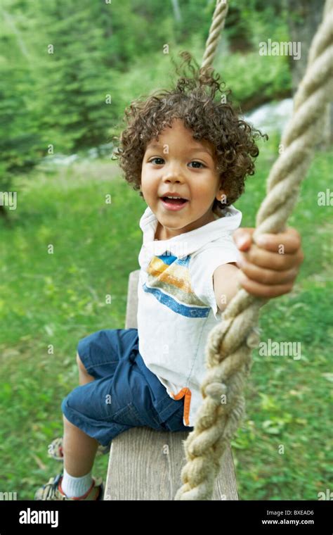 Cute Young Child Sitting On Swing Stock Photo Alamy