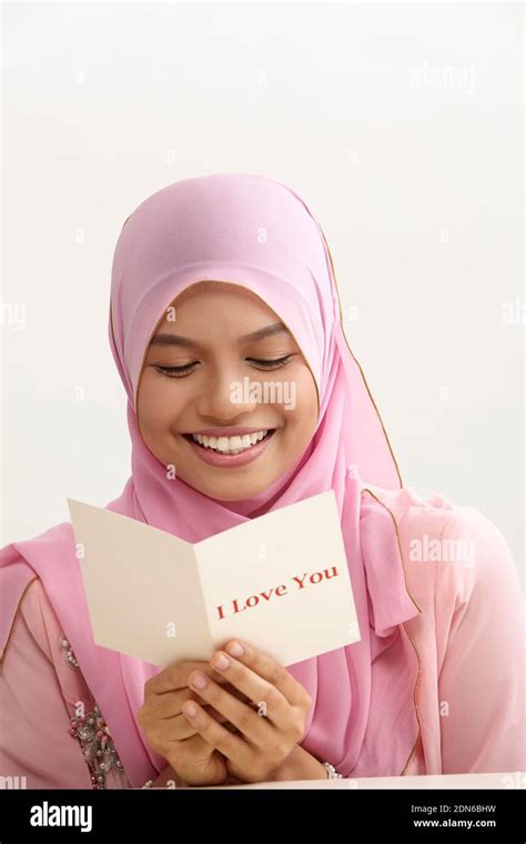 Smiling Young Woman Wearing Hijab Holding Greeting Card With I Love You