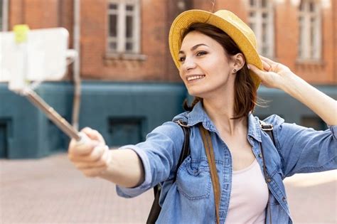 Free Photo Stylish Woman With Hat Taking A Selfie Outdoors