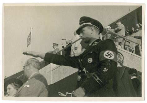 An SS man gives the Nazi salute at the start of the Berlin Olympics