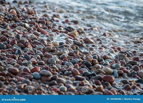 Abstract Details Of Rocky Beach Pebbles In Sunset By The Sea Stock