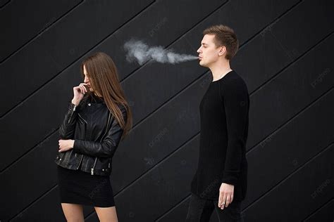woman protects herself from secondhand smoke in passive smoking concept image photo background