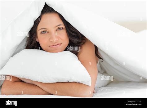 Smiling Woman Hugging A Pillow Stock Photo Alamy