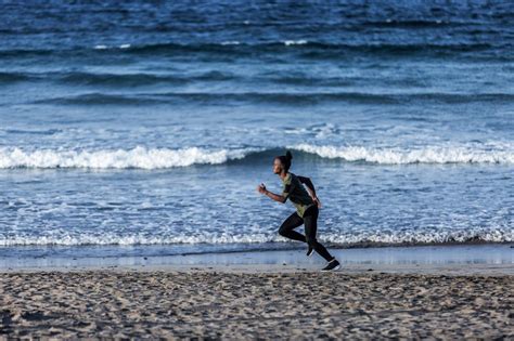 Free Stock Photo Of Black Man Sprinting Near Waving Sea Download Free