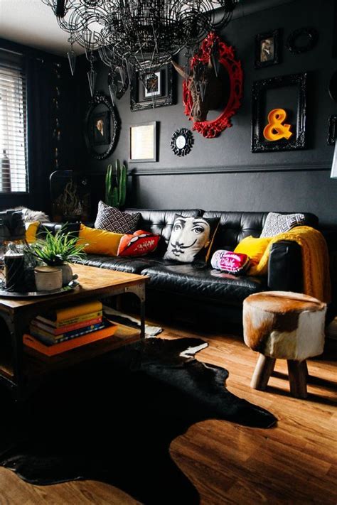 An Eclectic Space With Black Walls And Furniture A Unique Chandelier