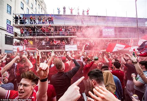 Liverpool Fans Clamber On Cars Straddle Traffic Lights And Scale Buses After Champions League