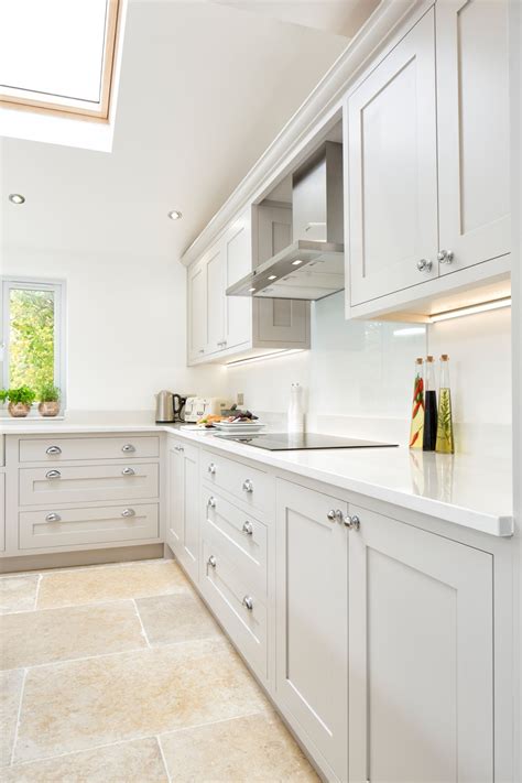Typical shaker style open shelving is given a contemporary twist with discreet lighting to showcase gleaming copperware. Maple & Gray: White & Grey Shaker Kitchen