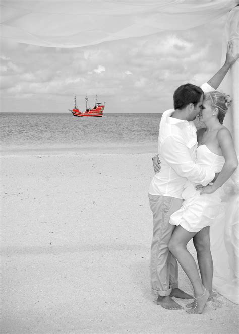 florida beach wedding on sand key with the pirate ship in the background just before sunset