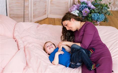 Mother Giving Good Night Kiss To Sleeping Son Lovely Mother Putting Son To Bed Stock Image