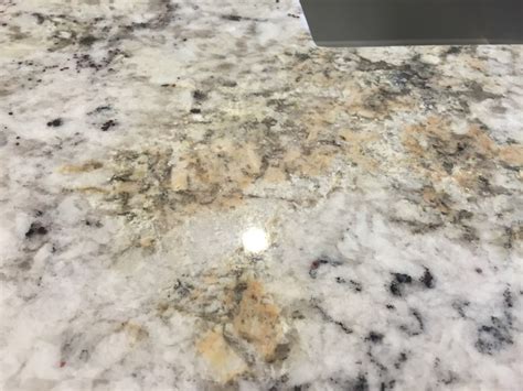 White ice granite, white subway tile with gray grout. Is this a defected white ice granite? (laminate, sink ...