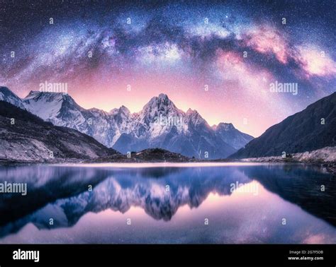 Milky Way Over Snowy Mountains And Lake At Night Stock Photo Alamy