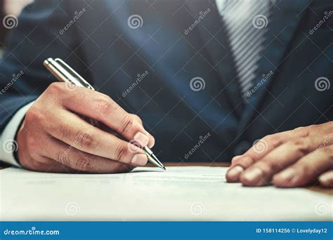 Businessman Writing On Paper Report In Office Concept Stock Photo