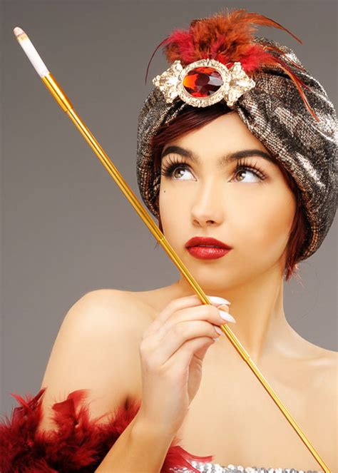 A cigarette holder is a fashion accessory, a slender tube in which a cigarette is held for smoking. 1920s Gold Extendable Cigarette Holder