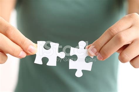 Hands Holding Two Matching Puzzle Pieces Stock Photo Royalty Free