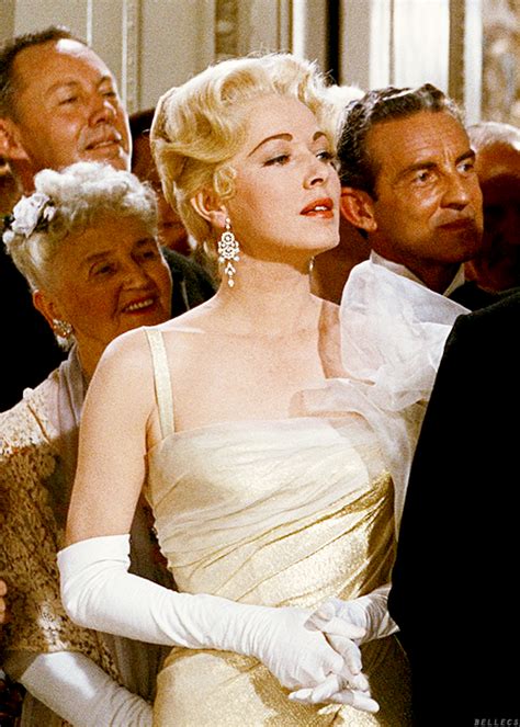 Marilyn Monroe In White Dress Surrounded By Men And Women Wearing Formal Clothing All Looking