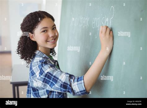 Portrait Of Schoolgirl Pretending To Be A Teacher In Classroom At