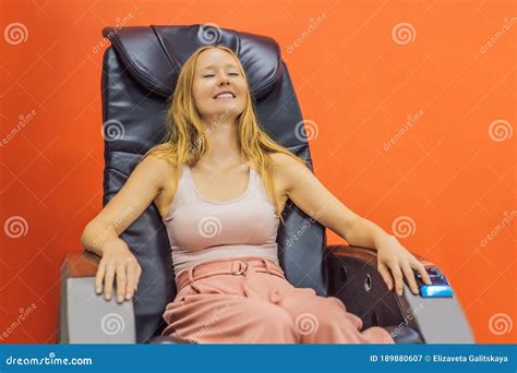 Beautiful Young Woman Relaxing On The Massage Chair In Airport Or In The Mall Stock Image
