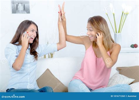 Two Happy Women High Fiving On Sofa At Home Stock Photo Image Of