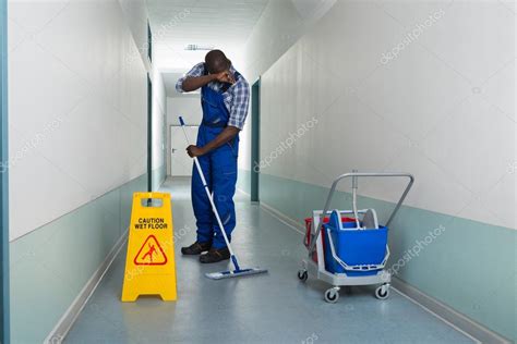 Male Janitor Mopping — Stock Photo © Andreypopov 78445284