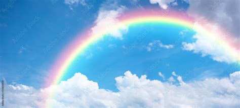 Rainbow In Blue Sky Stock Photo Adobe Stock