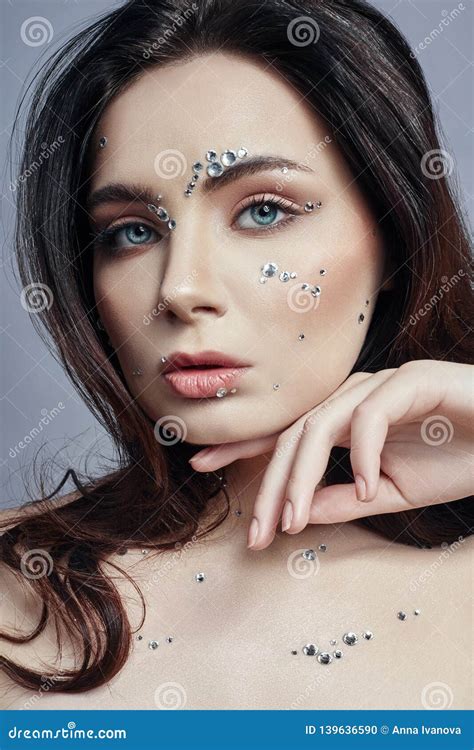 Art Portrait Of A Woman With Large Crystals Of Rhinestones On Her Face Chest And Body Perfect