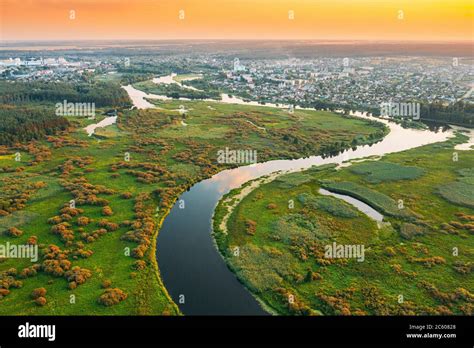 Belarus Aerial View Green Meadow And River Landscape Near Small Town
