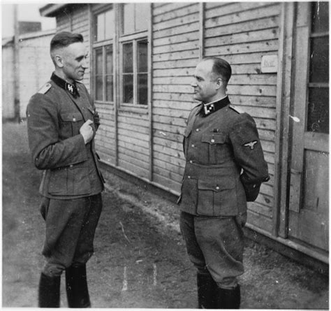 Two Ss Officers Stand And Talk Outside Of A Building At The Gross Rosen