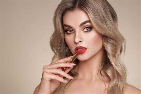 A Beautiful Young Blonde Woman Applying Lipstick Stock Image Image Of
