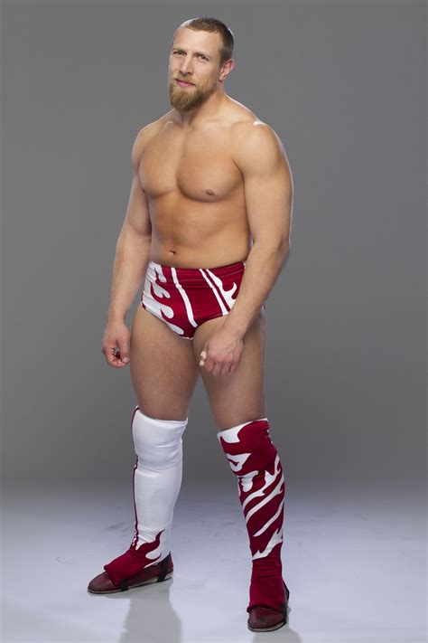 A Man In Red And White Wrestling Trunks Posing For The Camera With His