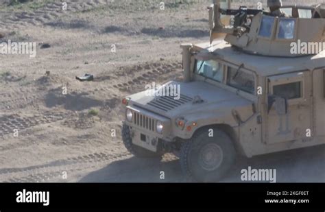 Soldier Firing Machine Gun From Turret Of Humvee Armored Vehicle Stock