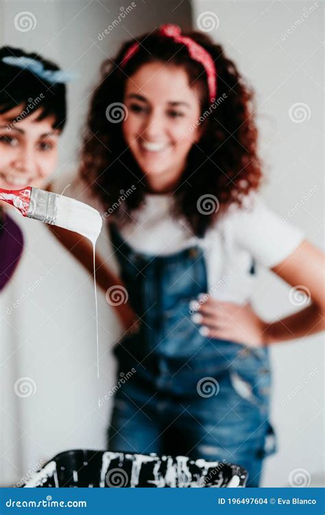 Happy Lesbian Couple Painting The Room Walls With White Color Do It Yourself And New Home