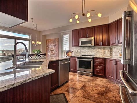 Tan brown granite is a beautiful dark colored stone that has beige speckling. Cherry Cabinet Kitchen with Granite Countertop | Cherry cabinets kitchen, Cherry cabinets, Home ...