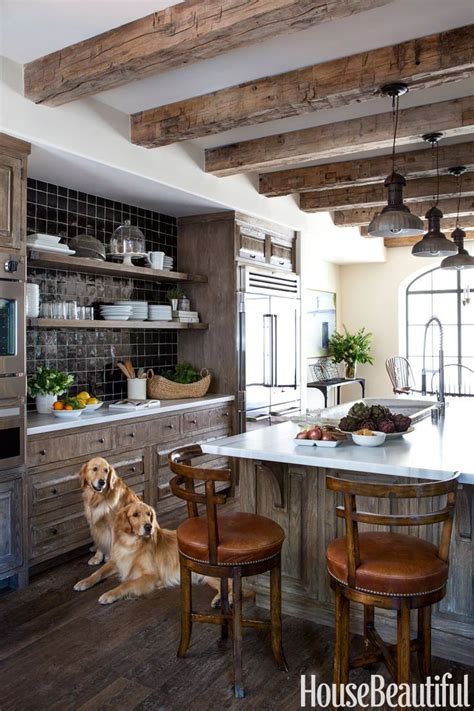 French country kitchen with raised ceiling boasting reclaimed timber beams and planking… the flared hood at stone arch is another lovely choice to blend the rustic with the refined… Top 27 Stunning Wood Ceiling Ideas | Ann Inspired
