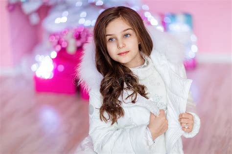 Very Cute Long Haired Young Girl With Blue Eyes In A White Coat Stock