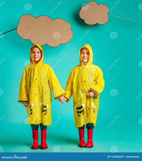 Twin Sisters In Raincoats Stock Image Image Of Sibling 134396369