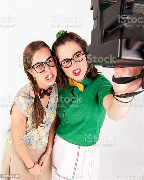Young Nerdy Girls Taking A Selfie With Instant Camera Stock Photo
