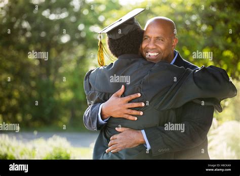 African American Student Celebrating Graduation With His Dad Stock