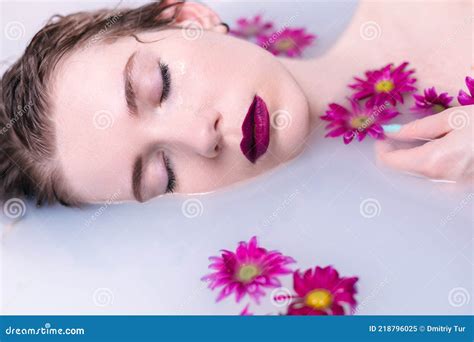 Beautiful Fashion Model Girl Taking A Milk Bath With Flowers Advertisement Of A Skincare