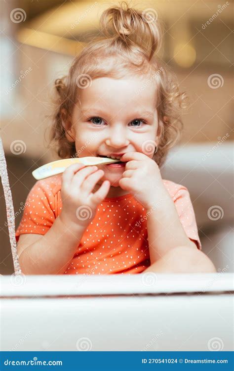 Happy Laughing Baby Girl Brushing Her Teeth In The Bath Stock Photo