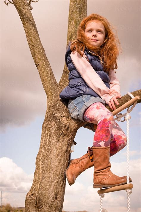Girl Climbing Tree In Countryside By Stocksy Contributor Craig Holmes Stocksy