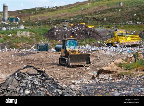 Bulldozer Working In Landfill Site And Seagulls With Methane Gas Burner