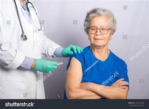 Doctor Giving Injection Senior Woman Hospital Stock Photo 1945673050
