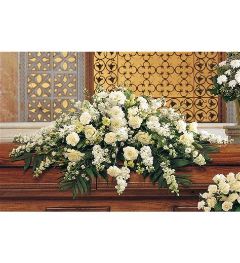 The blanket of flowers that covers the top of the casket, these arrangements are primarily sent by the spouse or immediate family. Pure White Casket Spray - TF194-1 ($190.76)